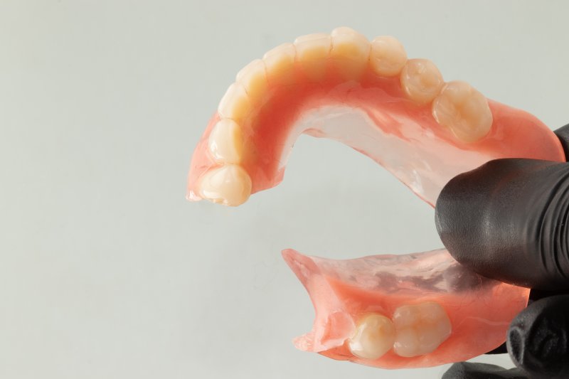 set of dentures in a glass of water